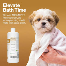 A small fluffy dog wrapped in a white towel on a warm tan background, with a bottle of AROMAPET shampoo shown at lower left and promotional text reading 'Elevate Bath Time.'.