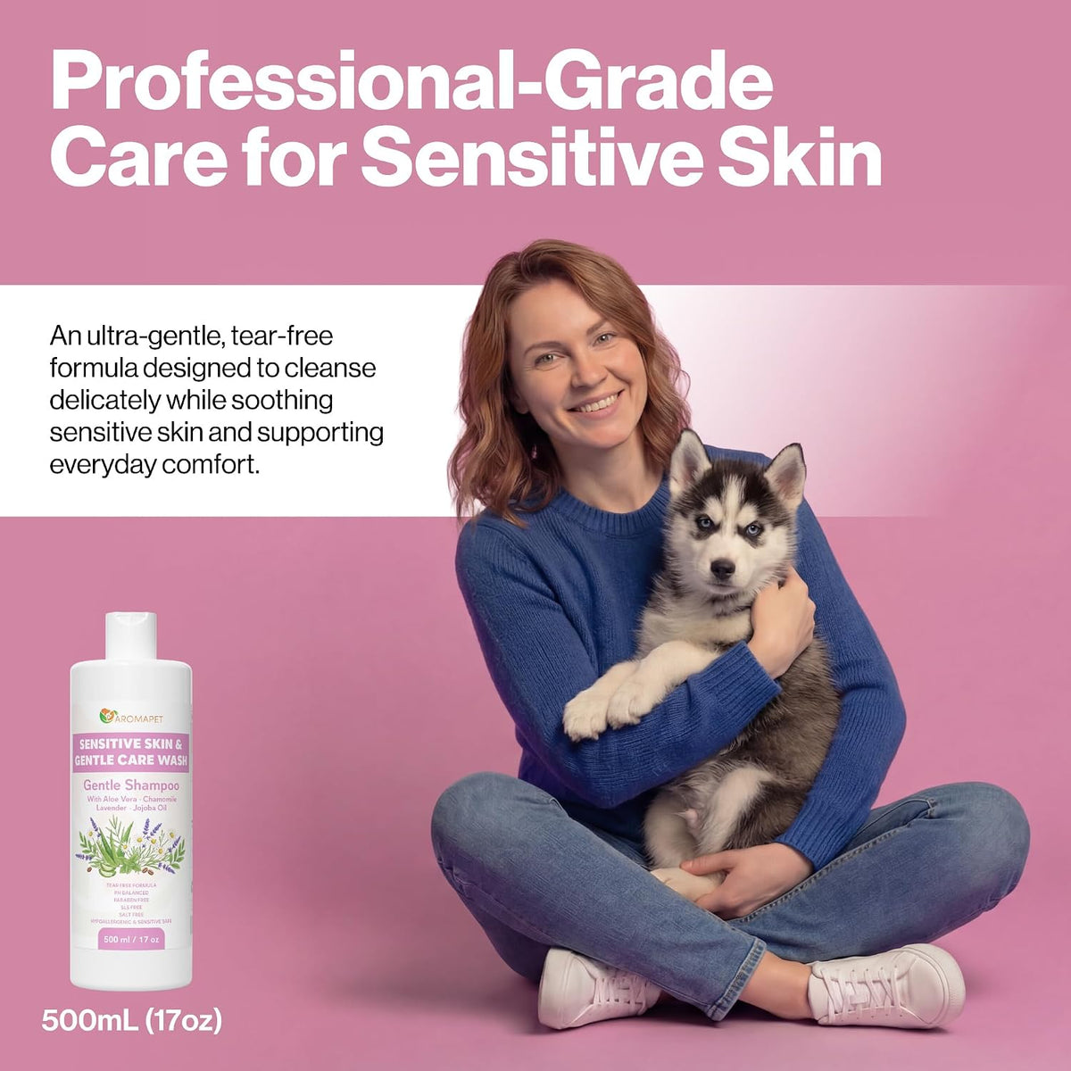 A woman sitting cross-legged on a pink background holds a husky puppy while promoting a pet skin care product. The image includes a bottle labeled 'Sensitive Skin & Itchy Skin Care Wash' and text reading 'Professional-Grade Care for Sensitive Skin' and '500mL (17oz)'.