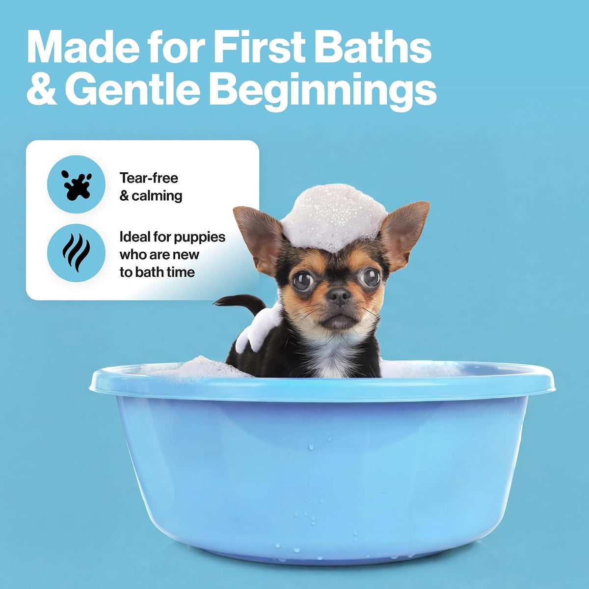 A small black-and-tan puppy sitting in a light blue plastic bath tub filled with foam, with large white marketing text reading 'Made for First Baths & Gentle Beginnings' and feature icons on a light blue background.