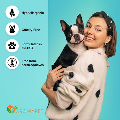 A woman in a cream polka-dot sweater holds a black-and-white Boston terrier dog against a bright aqua background. On the left, white circular icons with text read 'Hypoallergenic,' 'Cruelty-Free,' 'Formulated in the USA,' and 'Free from harsh additives,' with the AROMAPET logo at the bottom.
